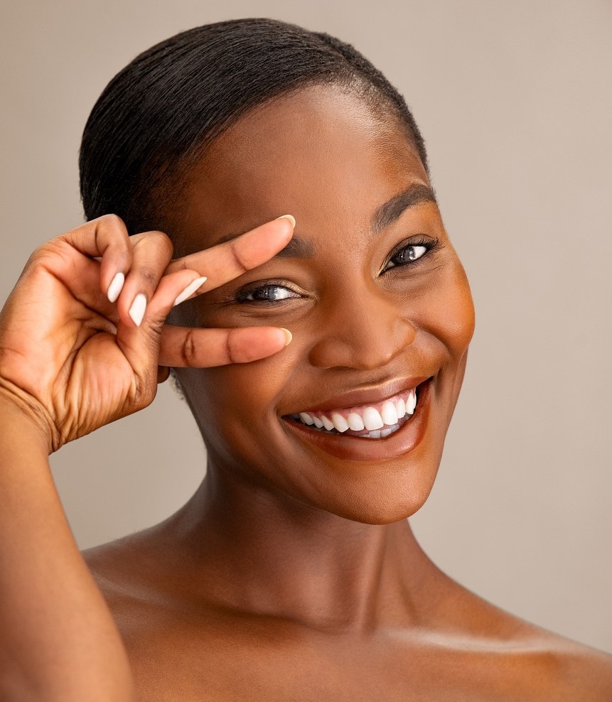 Portrait,Of,Smiling,Mature,Woman,With,Perfect,Skin,Showing,Victory